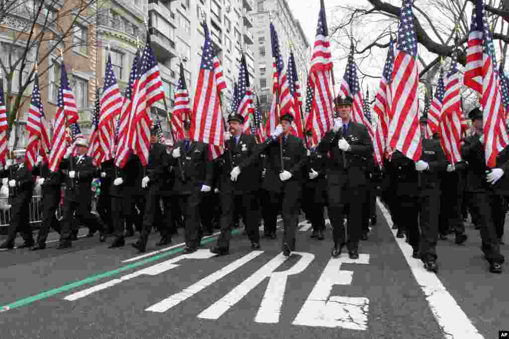 Участники парада держат флаги в честь 343 пожарных, погибших в терактах 11 сентября 2001 года. Нью-Йорк, 16 марта 2013 года