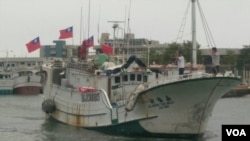 插着青天白日旗的台湾渔船驶出港口赴太平岛