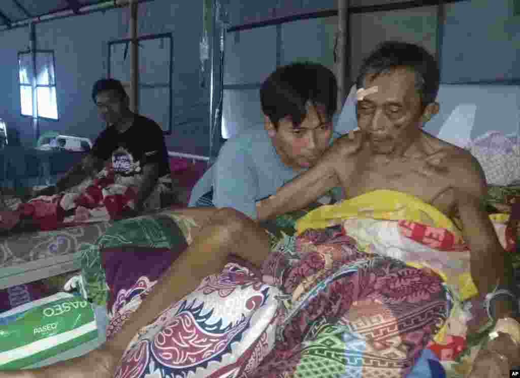 Earthquake-injured patients are treated at a makeshift hospital in Poso, Central Sulawesi, Indonesia, Sept. 29, 2018. 