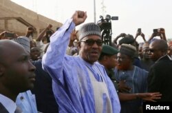 FILE - Nigerian President Muhammadu Buhari gestures as he arrives to cast a vote in Nigeria's presidential election at a polling station in Daura, Katsina State, Nigeria, Feb. 23, 2019.