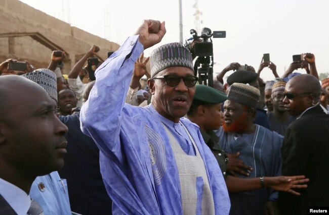 FILE - Nigerian President Muhammadu Buhari gestures as he arrives to cast a vote in Nigeria's presidential election at a polling station in Daura, Katsina State, Nigeria, Feb. 23, 2019.