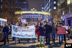 FILE - Protesters march on Cleveland's Huron Road on Dec. 29, 2015, the day after a grand jury declined to indict Cleveland Police Officer Timothy Loehmann in the fatal shooting of Tamir Rice on Nov. 22, 2014.