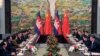 Cambodia's Prime Minister Hun Sen (2nd L) and China's President Xi Jinping (R) attend a meeting at Xijiao Hotel in Shanghai May 18, 2014. REUTERS/Kenzaburo Fukuhara