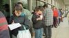 Mercedes Garcia of El Salvador fills in the application for her new ?green card? while waiting in a predawn line outside the Immigration and Naturalization Service office on Wednesday, March 20, 1996 in Los Angeles. Wednesday was the deadline to apply for