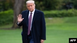 FILE: US President Donald Trump walks from Marine One after arriving on the South Lawn of the White House in Washington, DC, October 1, 2020, following campaign events in New Jersey. 