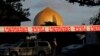 FILE - A police officer stands guard in front of the Al Noor Mosque in Christchurch, New Zealand, March 17, 2019, where one of the two mass shootings occurred.