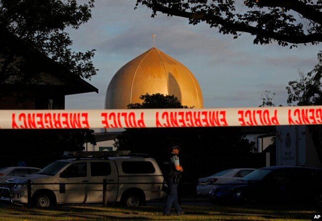 FILE - A police officer stands guard in front of the Al Noor Mosque in Christchurch, New Zealand, March 17, 2019, where one of the two mass shootings occurred.