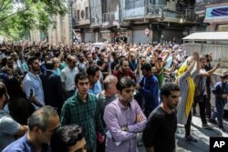 A group of protesters chant slogans at the old grand bazaar in Tehran, Iran, June 25, 2018.