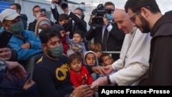 Pope Francis (2R) speaks with refugees at the Reception and Identification Centre (RIC) in Mytilene on the island of Lesbos, Greece, Dec. 5, 2021. 