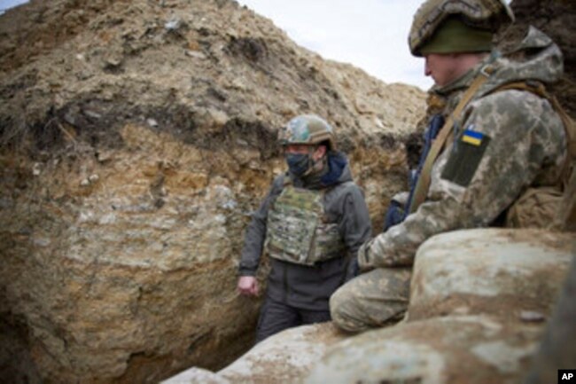 Ukrainian President Volodymyr Zelenskyy looks on as he visits the war-hit Donbas region, eastern Ukraine, Thursday, April 8, 2021.