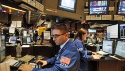 Traders work at the New York Stock Exchange on the last trading day of the year in New York. Registered exchanges, like NYSE Euronext, have seen electronic and alternative exchanges steadily grow