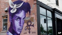 FILE - A mural honoring the late Prince adorns a building in the Uptown area of Minneapolis, Aug 28, 2016.