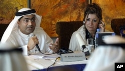 Emirati blogger and human rights activist Ahmed Mansour speaks as the director of Human Rights Watch's Middle East and North Africa division, Sarah Leah Whitson listens on, during a press conference in Dubai, UAE, January 26, 2011