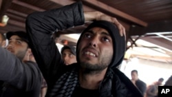 An Egyptian man reacts as he watches a televised court verdict confirming death sentences against 21 people for their role in a deadly 2012 soccer riot, in a coffee shop in Port Said, Egypt, Mar. 9, 2013. 