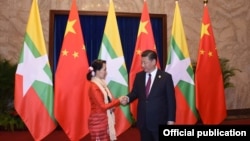 Myanmar State Counsellor Aung San Suu Kyi (L) shakes hands with Chinese President Xi (MOI)