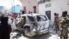 FILE - Security forces observe the scene of a suicide bombing that injured Somalia's government spokesperson Mohamed Ibrahim Moalimuu in Mogadishu, Somalia, Jan. 16, 2022. 