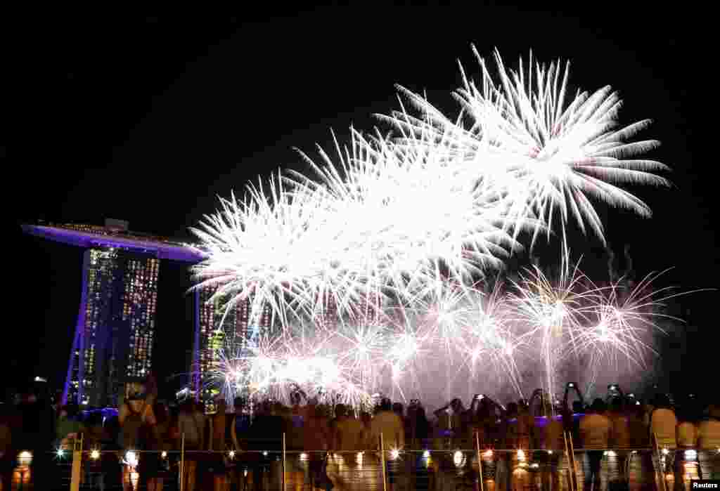 Kembang api meletus dan menerangi langit di atas Marina Bay menjelang perayaan Tahun Baru di Singapura, 31 Desember 2018.&nbsp;