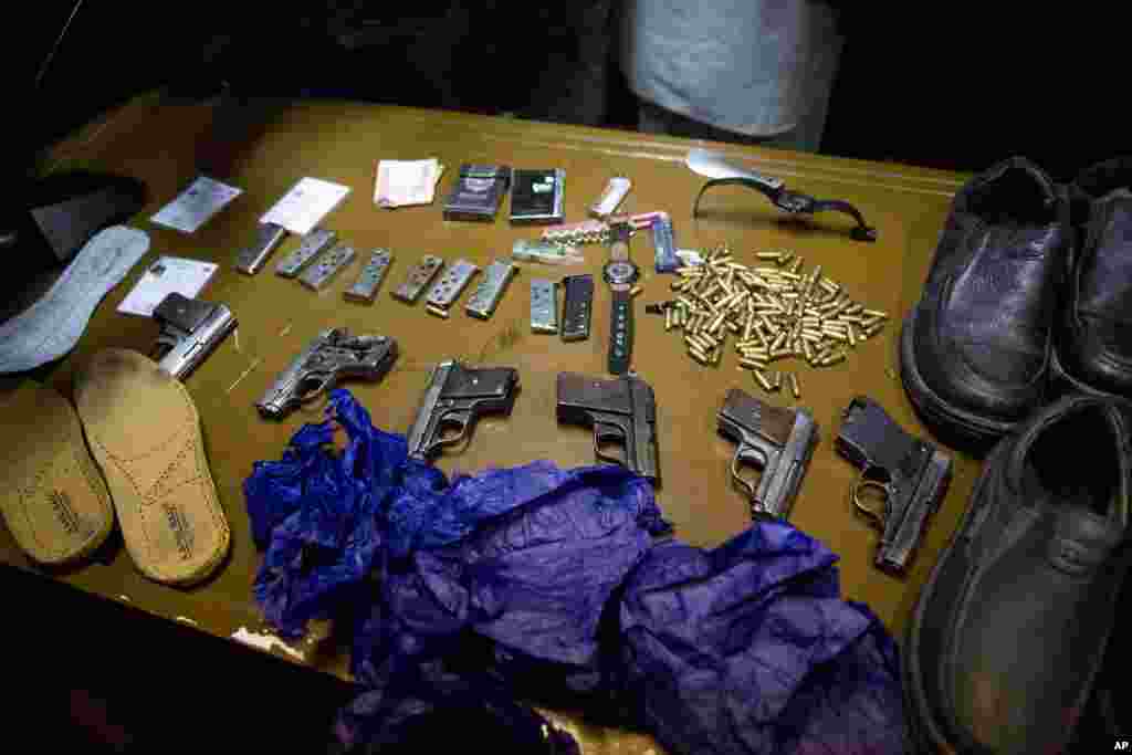 Afghanistan&#39;s intelligence service displays some of the Serena hotel attackers&#39; weapons and belongings during a press conference at the Interior ministry in Kabul, March 21, 2014.