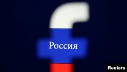 FILE - A 3D printed Facebook logo is seen in front of a displayed Russian flag in this photo illustration, Aug. 3, 2018.