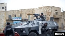 Jordanian policemen stand guard after ending security operations in the vicinity of Karak Castle, where armed gunmen carried out an attack in the city of Karak, Jordan, Dec. 19, 2016. Islamic State claims responsibility for shootout.