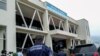 FILE - Delegates walk outside the Gatuna one-stop border post at Gicumbi, northern Rwanda, January 31, 2022. REUTERS