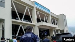 FILE - Delegates walk outside the Gatuna one-stop border post at Gicumbi, northern Rwanda, January 31, 2022. REUTERS