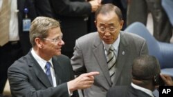 German Foreign Minister Guido Westerwelle speaks with U.N. Secretary-General Ban Ki-moon before a Security Council meeting on Children and Armed Conflict at the UN headquarters in New York, July 12, 2011
