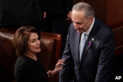 House Minority Leader Nancy Pelosi of California talks with Senate Minority Chuck Schumer of New York before the State of the Union address to a joint session of Congress on Capitol Hill in Washington, Jan. 30, 2018.