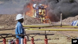 FILE - An oil well undergoes testing in the Lake Albertine region of western Uganda in 2010.