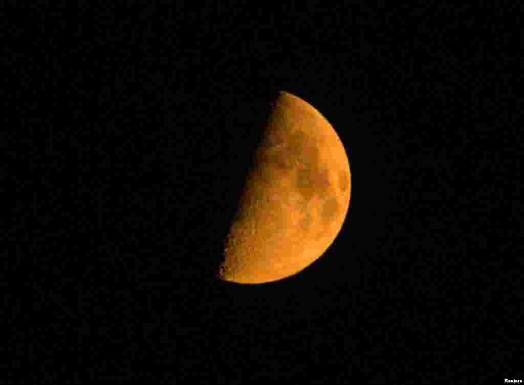 The moon appears red as pictured through smoke from the Chelan Complex fire in Manson, Washington, Aug. 22, 2015.