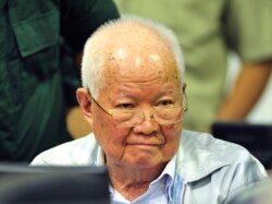 In this photo released by the Extraordinary Chambers in the Courts of Cambodia, Khieu Samphan, former Khmer Rouge head of state, sits in a court room before a hearing at the U.N.-backed war crimes tribunal in Phnom Penh, Cambodia, Friday, Nov. 16, 2018.