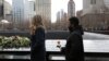 FILE - Attendees wait to leave roses during a commemoration ceremony of the 25th anniversary of the 1993 World Trade Center bombing at the north reflecting pool of the National September 11 Memorial & Museum at the World Trade Center site in the Manhattan borough of New York, Feb. 26, 2018. 