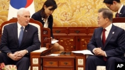 U.S. Vice President Mike Pence, left, speaks with South Korean President Moon Jae-in during a meeting at the presidential office Blue House in Seoul, Feb. 8, 2018. 