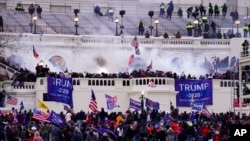 FILE - Violent protesters, loyal to President Donald Trump, storm the Capitol, Jan. 6, 2021, in Washington. It was a stunning day as a number of lawmakers and then the mob of protesters tried to overturn America's presidential election, undercut the nation's democracy and keep Democrat Joe Biden from replacing Trump in the White House.