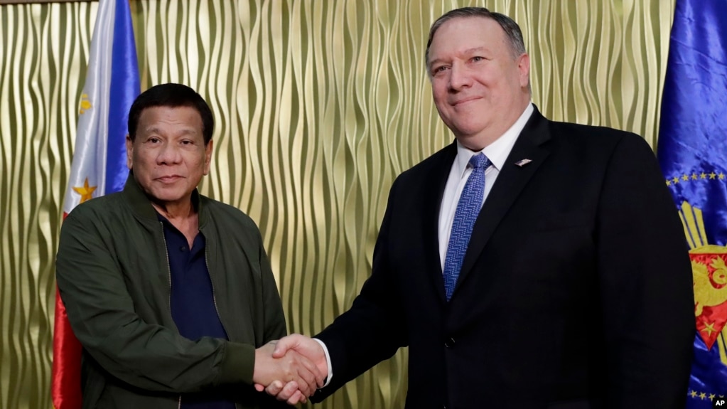 Philippine President Rodrigo Duterte, left, greets U.S. Secretary of State Mike Pompeo at Villamor Air Base in Pasay city southeast of Manila, Philippines, Feb. 28, 2019. Pompeo arrived for talks on the two countries' relations and mutual defense treaty.