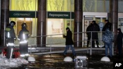 Police stand at the entrance of a supermarket, after an explosion in St. Petersburg, Russia, Dec. 27, 2017. 