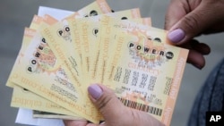 A person shows Powerball tickets she bought on Jan. 12, 2016, in San Lorenzo, Calif.
