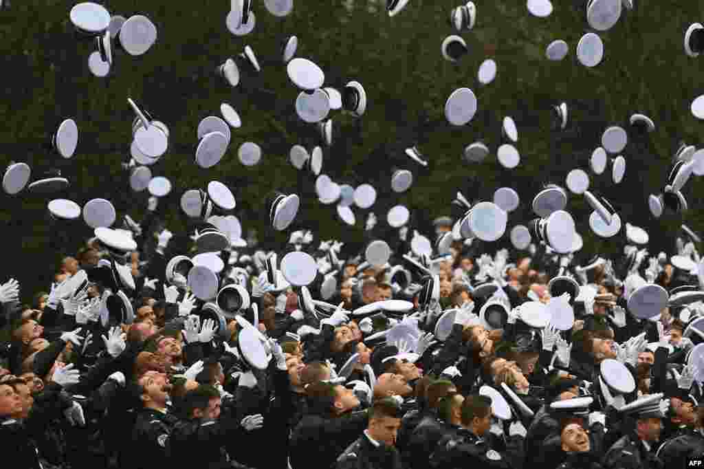 Police officers celebrate during a ceremony marking the end of the school year at the Ecole Nationale de Police in Nimes, southern France.