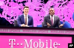FILE - Saturday Night Live Weekend Update's Colin Jost (left) and Michael Che are seen at a T-Mobile event in Las Vegas, Nevada, Jan. 5, 2017. Saturday Night Live has seen its ratings soar during the presidential campaign as well as after the election.