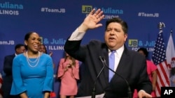 Democratic gubernatorial candidate J.B. Pritzker, right, celebrates winning the Democratic gubernatorial primary with lieutenant governor candidate Juliana Stratton, March 20, 2018, in Chicago.