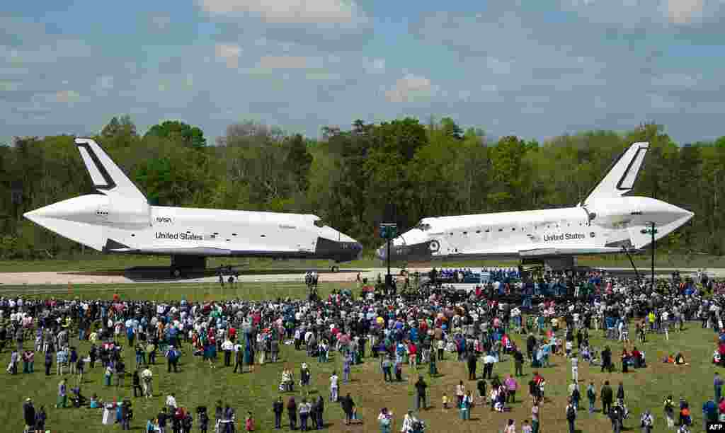 Space Shuttles Enterprise, left, and Discovery meet nose-to-nose at the beginning of a transfer ceremony at the Smithsonian's Steven F. Udvar-Hazy Center in Chantilly, Virginia, April 19, 2012. (NASA/Smithsonian Institution/Carolyn Russo)