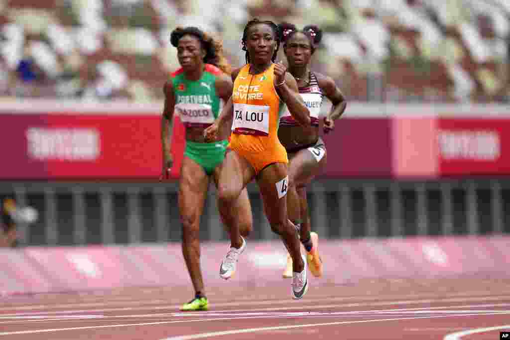 Marie-Josee Ta Lou, of the Ivory Coast, wins a heat in the women&#39;s 100-meter run at the 2020 Summer Olympics, Friday, July 30, 2021, in Tokyo. (AP Photo/Martin Meissner)