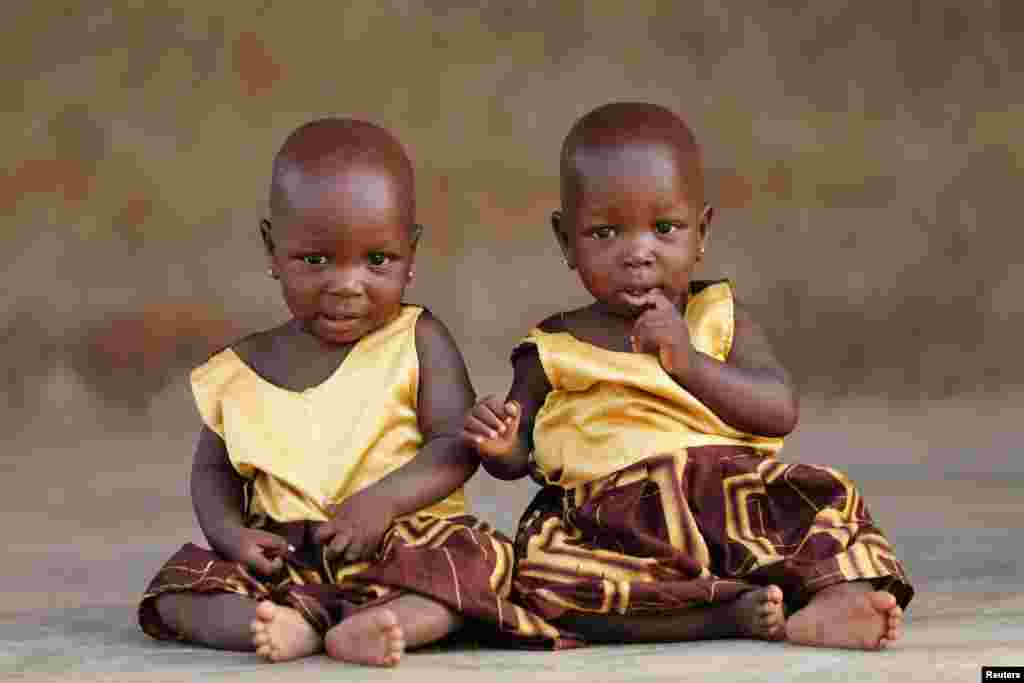 Identical twins Taiwo Adejare and Kehinde Adejare pose for a picture in Igbo Ora, Oyo State, Nigeria.