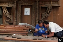 "Silpakars," or woodworkers from the Newar ethnic community, work on a restoration project in Lalitpur, Nepal, July 19, 2017. Centuries-old Char Narayan and Hari Shankara temples were destroyed by the massive April 2015 earthquake. A team of dedicated woodworkers is now trying to restore Nepal's heritage.
