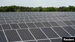 FILE - Rows of solar panels at the Toms River Solar Farm which was built on an EPA Superfund site in Toms River, New Jersey, May 26, 2021.