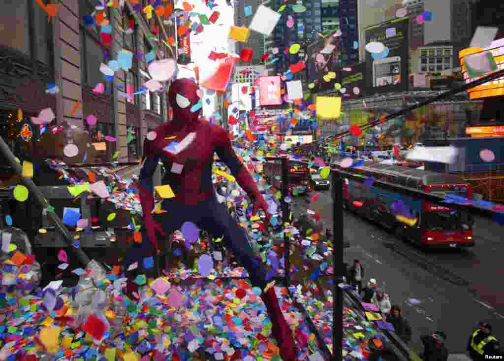 A man dressed up as Spiderman poses for photos as he takes part in the annual &quot;air worthiness&quot; test of confetti in Times Square in New York, Dec. 29, 2013. 
