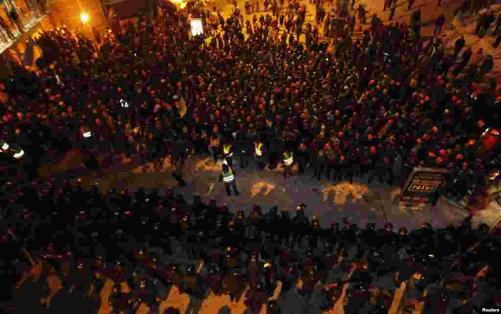 Pro-European integration protesters line up in front of riot police in Kyiv, Dec. 11, 2013.