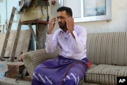 FILE - Yemeni businessman Ali Awad Habib recounts the torment he suffered in prison, where he said he was beaten with wires and wooden clubs and given electrical shocks, in this May 8, 2017, photo in Aden, Yemen.