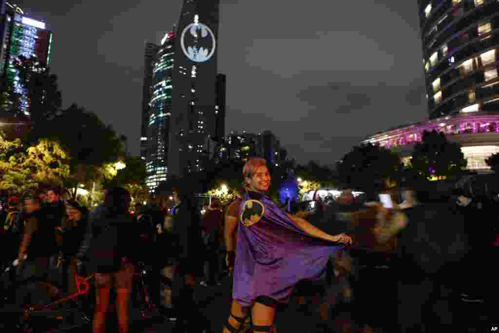 Stephanie Salgado poses with her cape during the lighting of a Bat-signal commemorating Batman&#39;s 80th anniversary in Mexico City, Sept. 21, 2019.