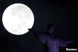 A full moon 'supermoon' is pictured next to the statue of Christ the Redeemer in Rio de Janeiro, Brazil, Feb. 1, 2018.